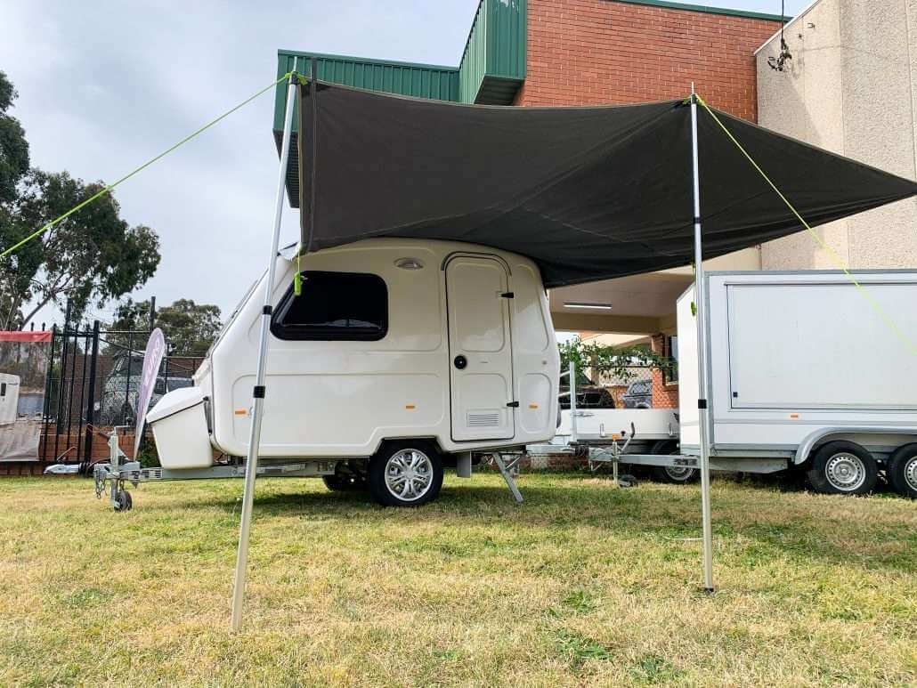 An awning displayed on a caravan on a grass land